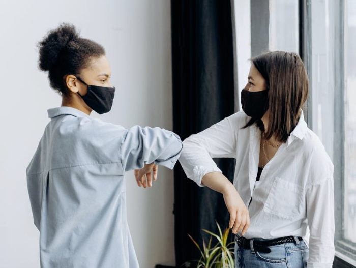 2 girls elbow bumping