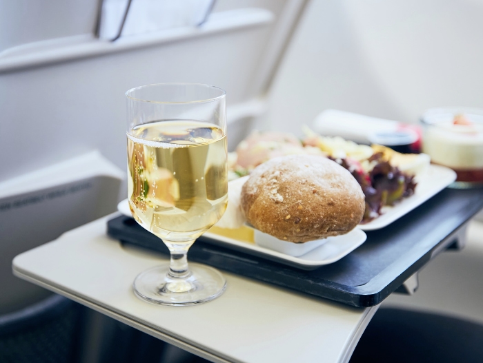 glass of wine on table in airplane