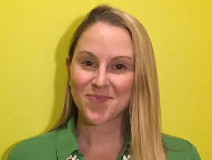 women with blonde hair in front of yellow background