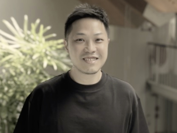 asian man smiling wearing black shirt