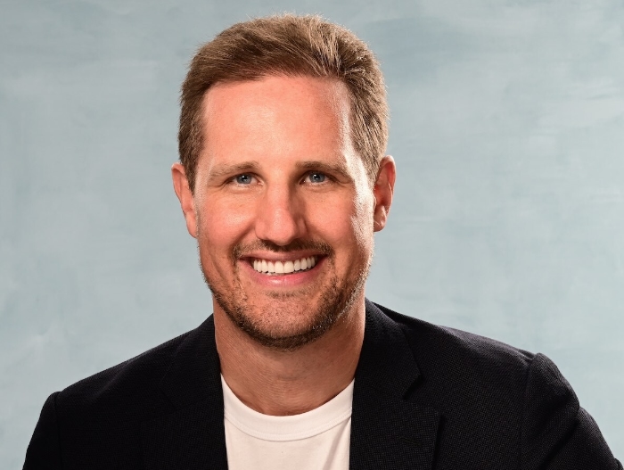 man smiling wearing black jacket and white shirt