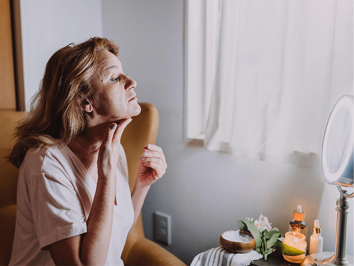 image of woman looking in the mirror