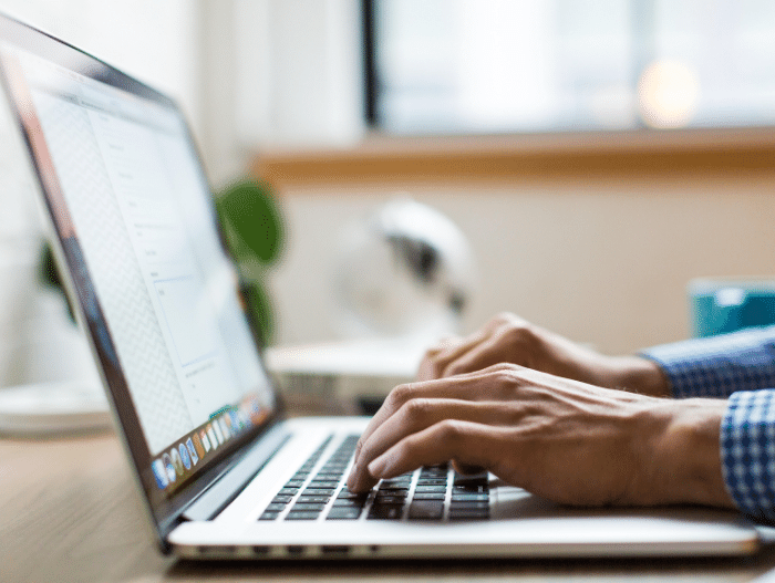 image of man on computer typing