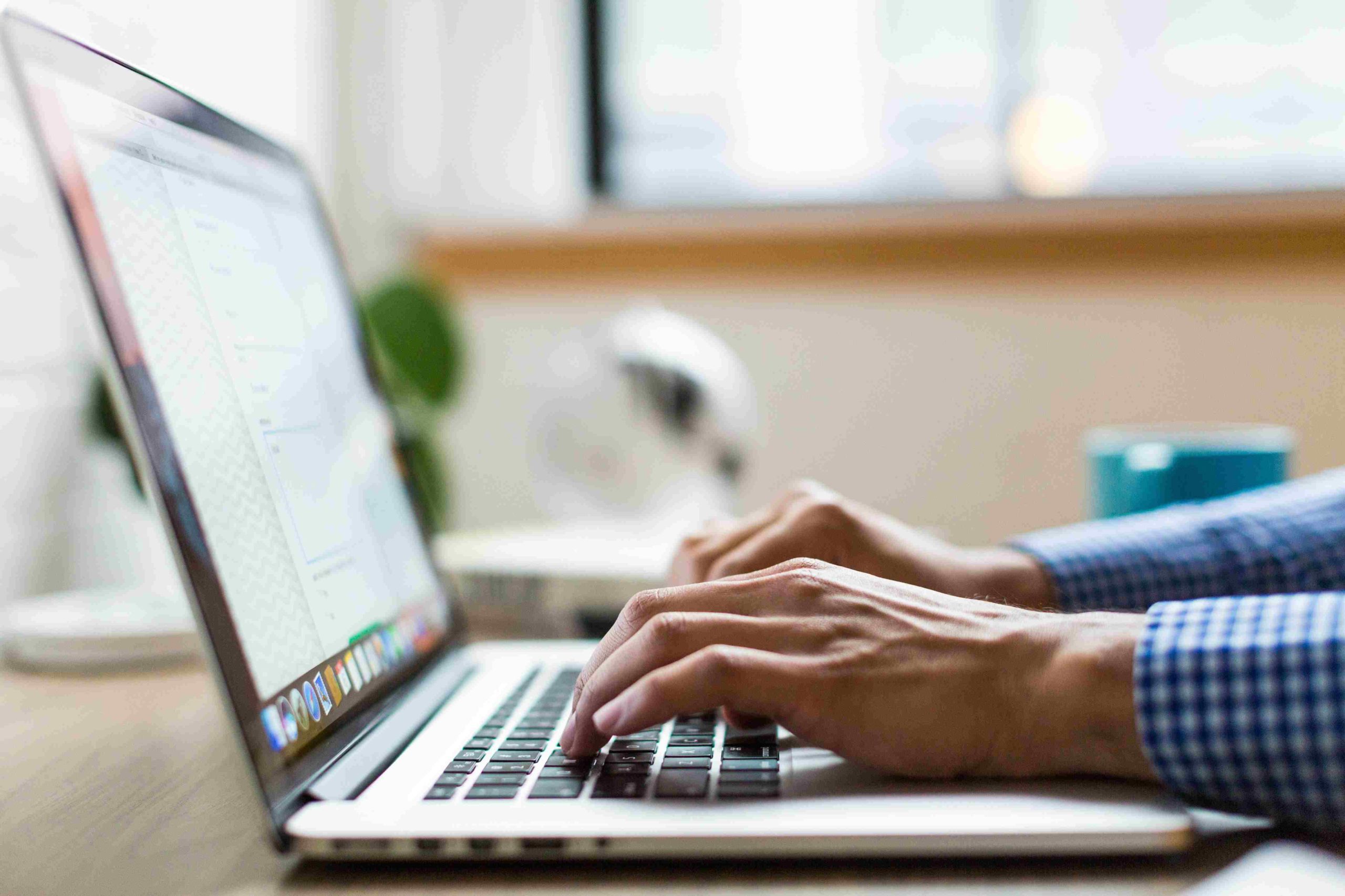 image of man on computer typing