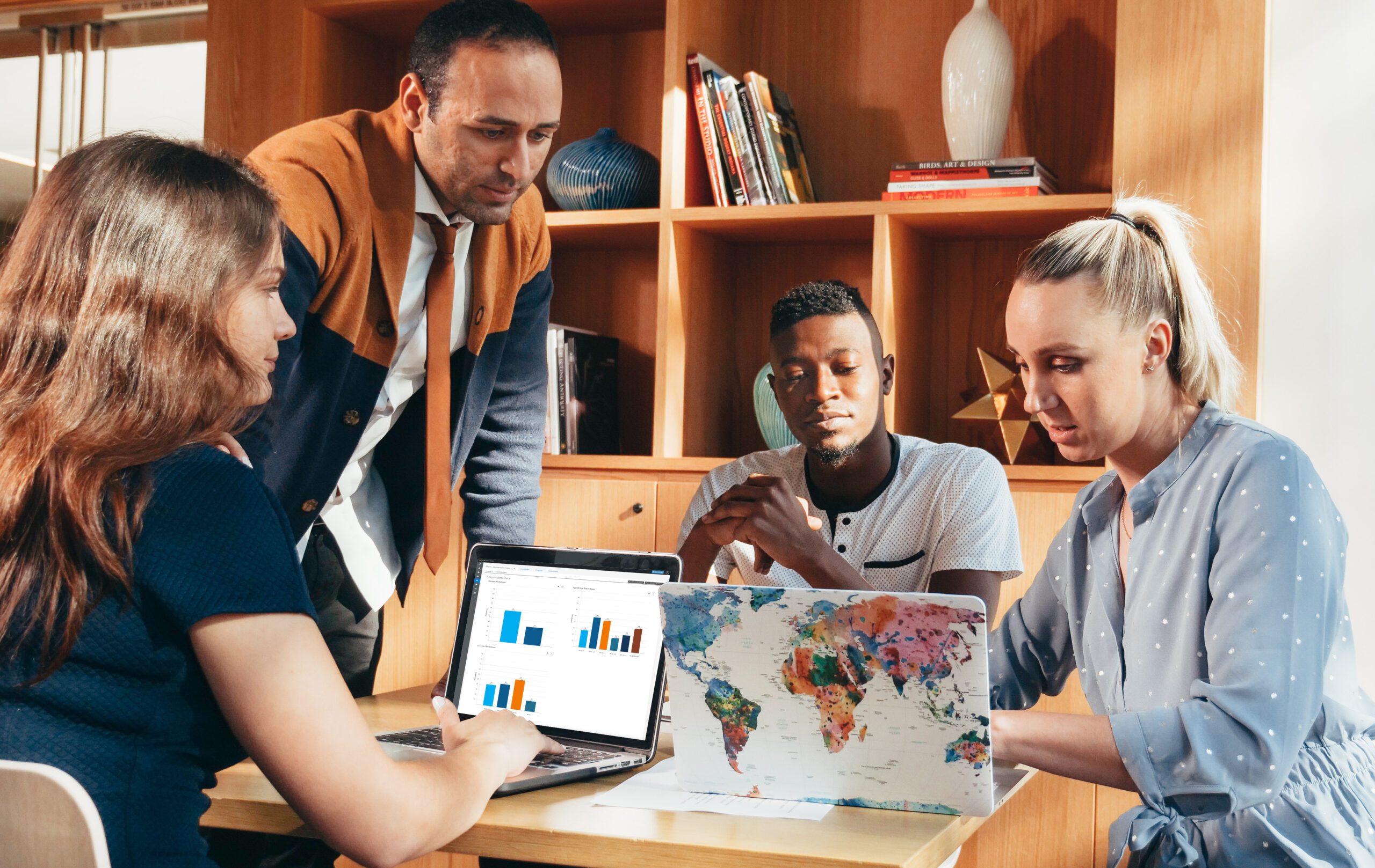 group of people around a table looking at data