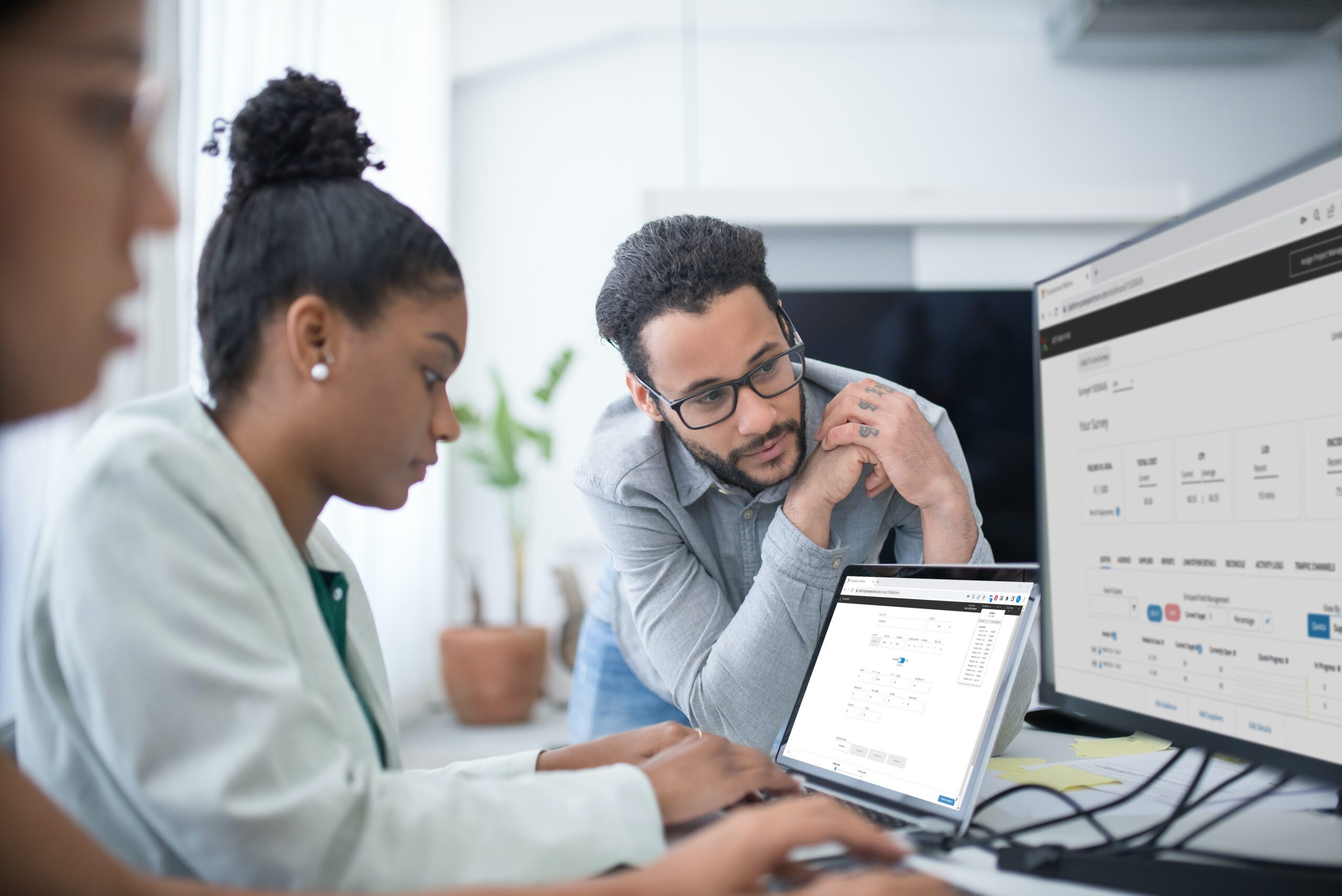 man and woman looking at computer monitor